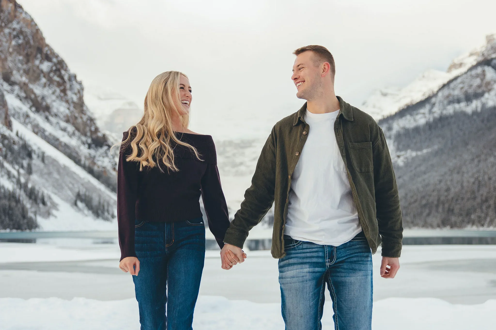144_couple-walking-lake-louise-winter-mountains.webp