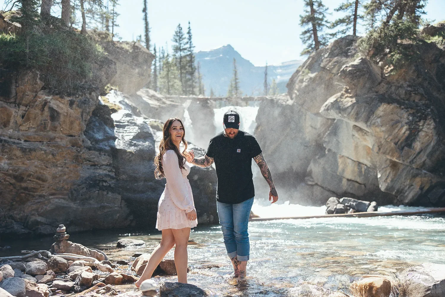 107_Couple-Walking-Mountain-River-Waterfall-Canadian-Rockies-Engagement.webp