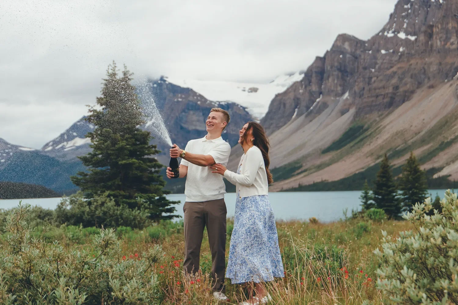 106_Couple-Popping-Champagne-Celebration-Canadian-Rockies-Mountain-Lake.webp