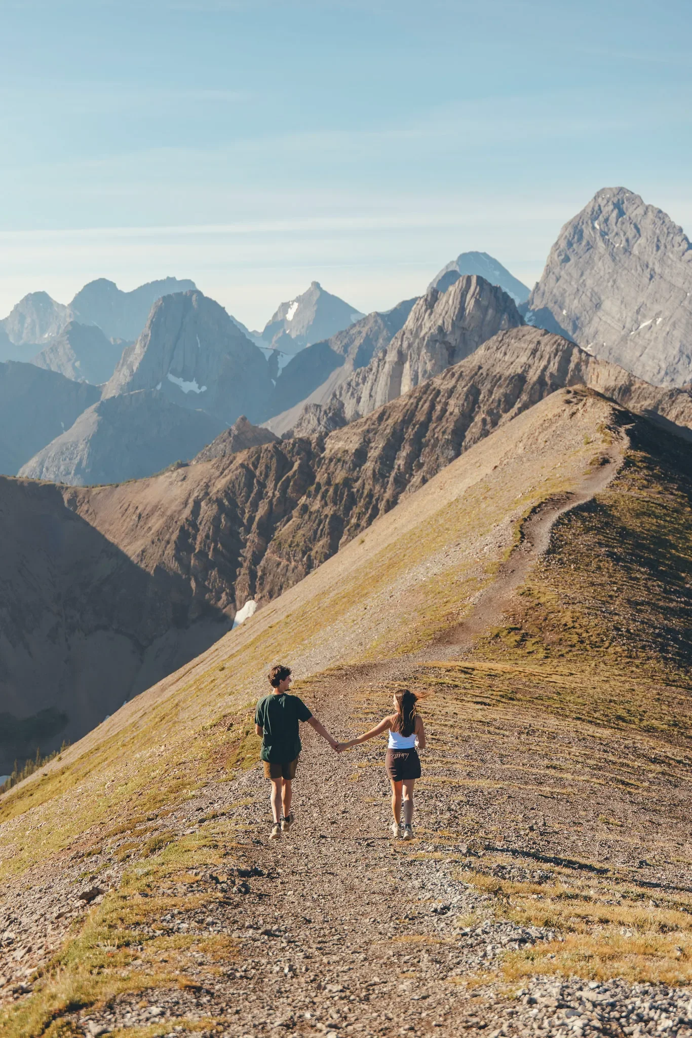 122_Couple-Walking-Holding-Hands-Mountain-Ridge-Trail-Canadian-Rockies.webp