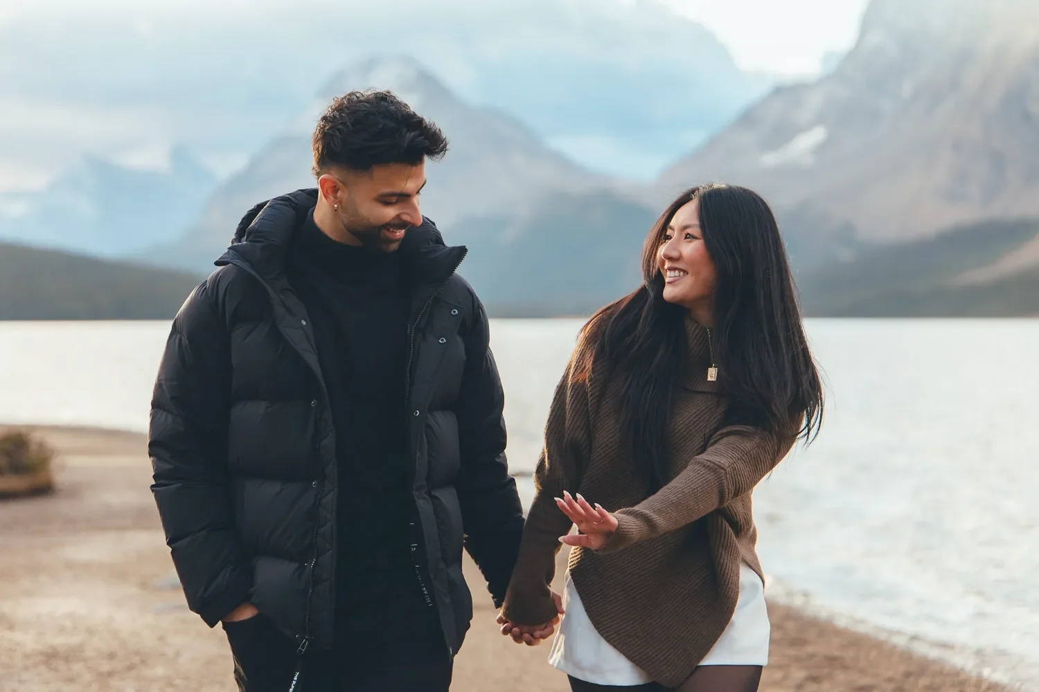 105_Couple-Engagement-Walking-Alpine-Lake-Banff.webp