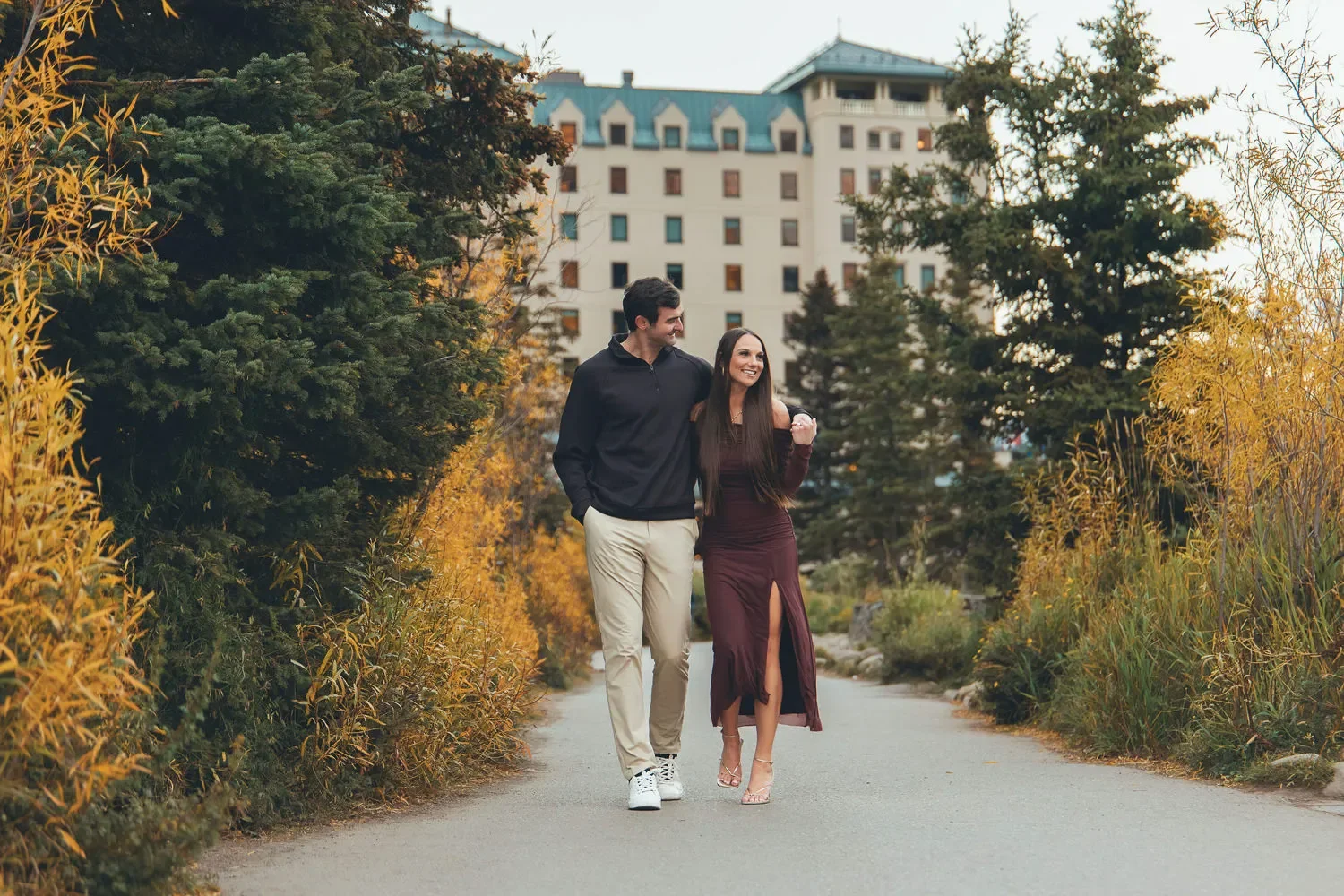 106_Couple-Walking-Lake-Louise-Fairmont-Chateau-Autumn-Trail.webp