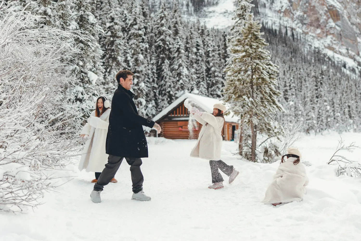 104_family-playing-snow-canadian-rockies-winter-forest.webp