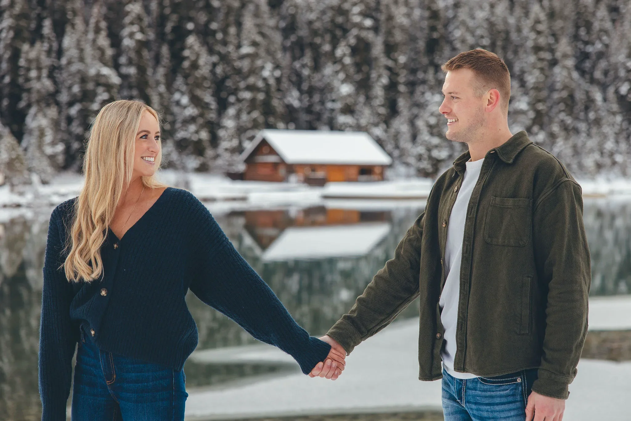 135_Couple-Holding-Hands-Snowy-Alpine-Lake-Canadian-Rockies.webp
