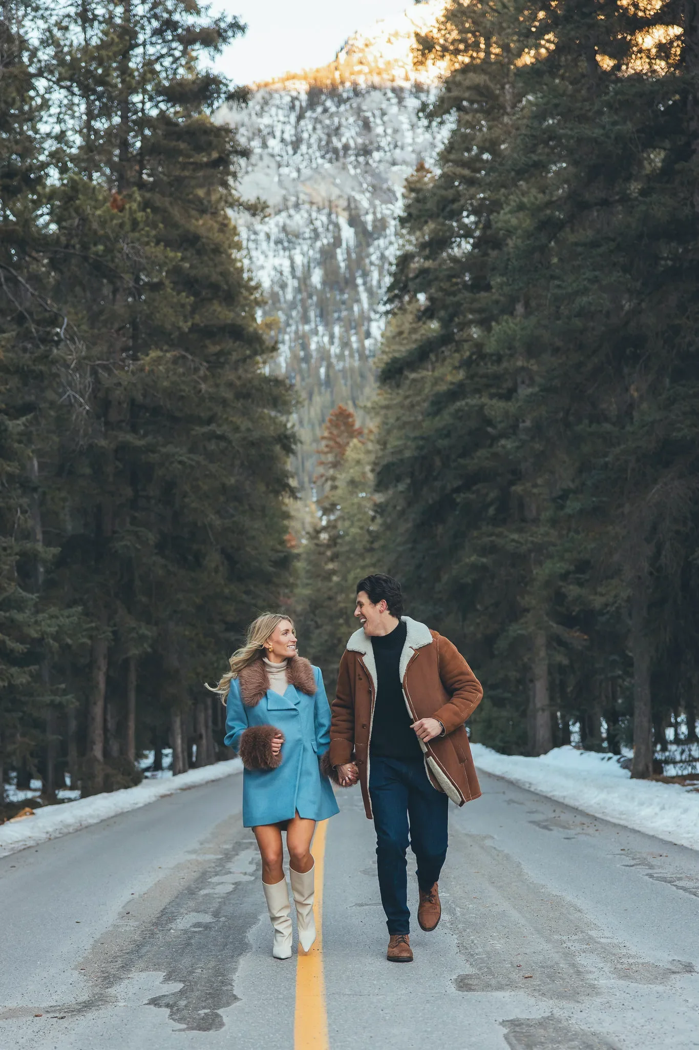 156_Couple-Walking-Mountain-Road-Canadian-Rockies-Engagement.webp