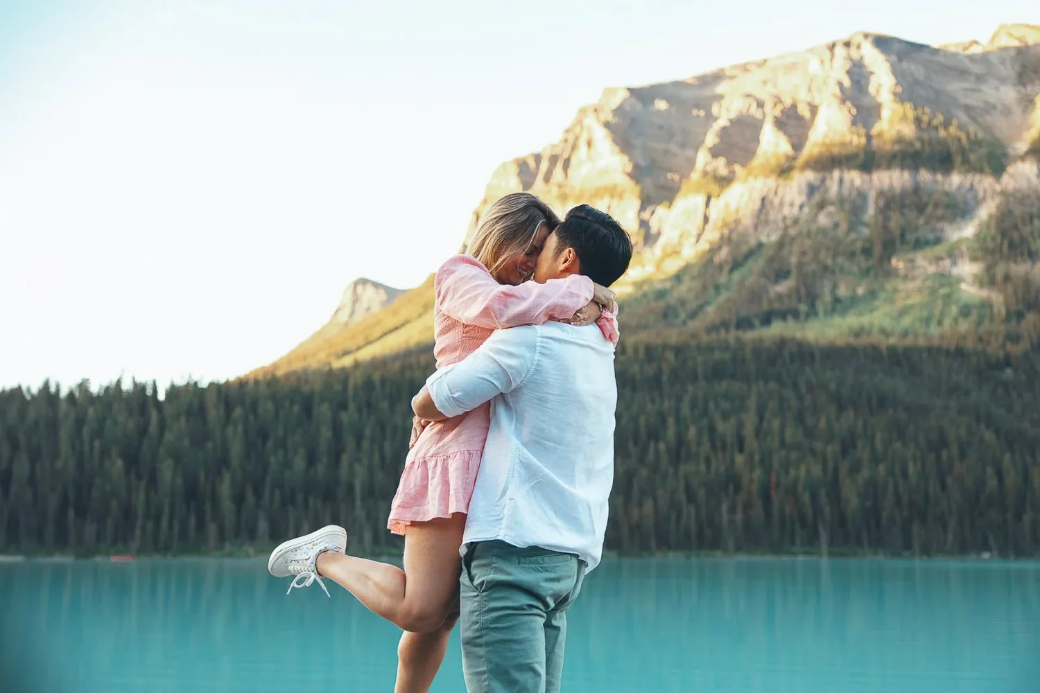 102_Couple-Embracing-Lake-Louise-Banff-Mountain-Landscape-Golden-Hour.webp