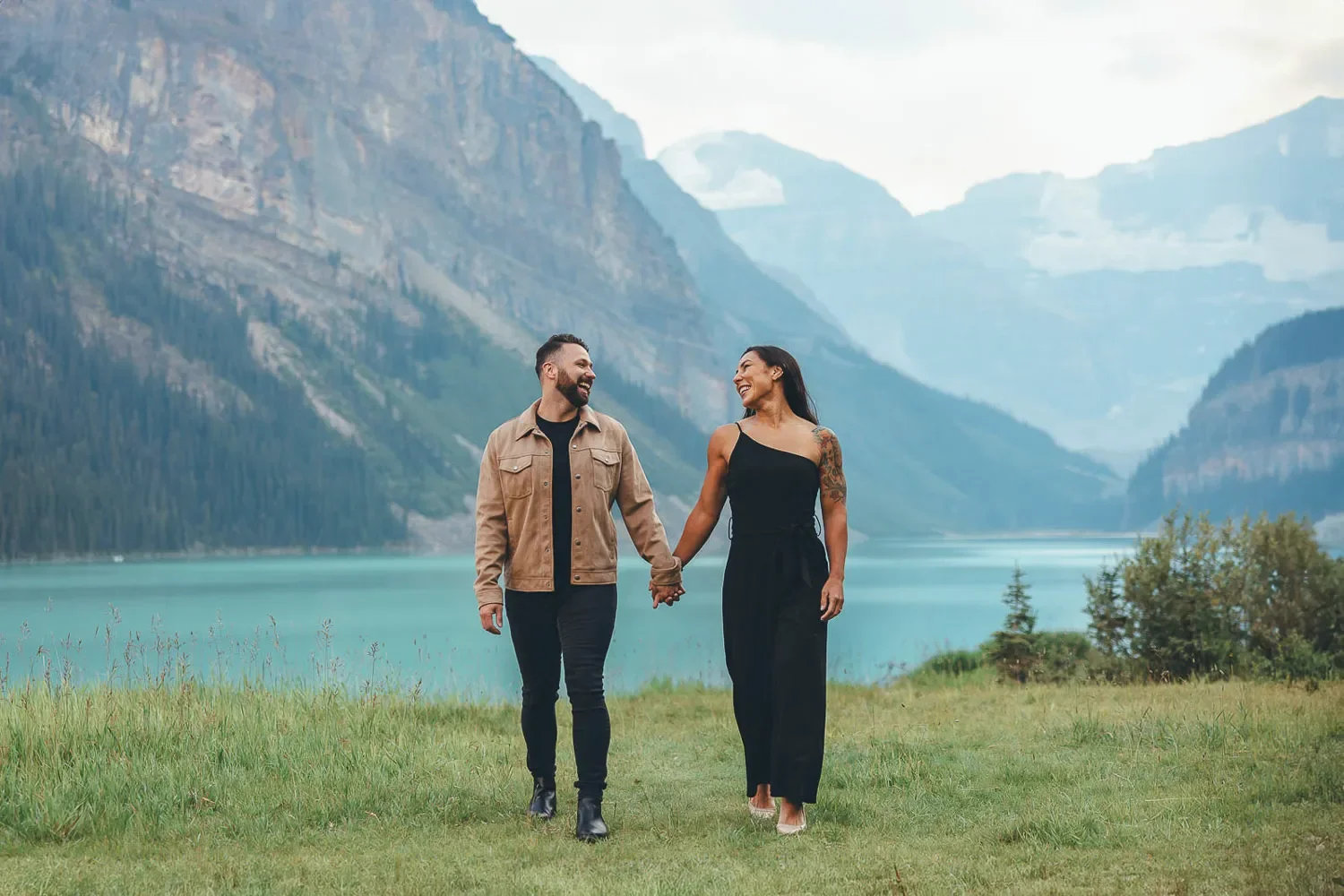 120_Couple-Walking-Lake-Louise-Banff-Mountain-Landscape.webp