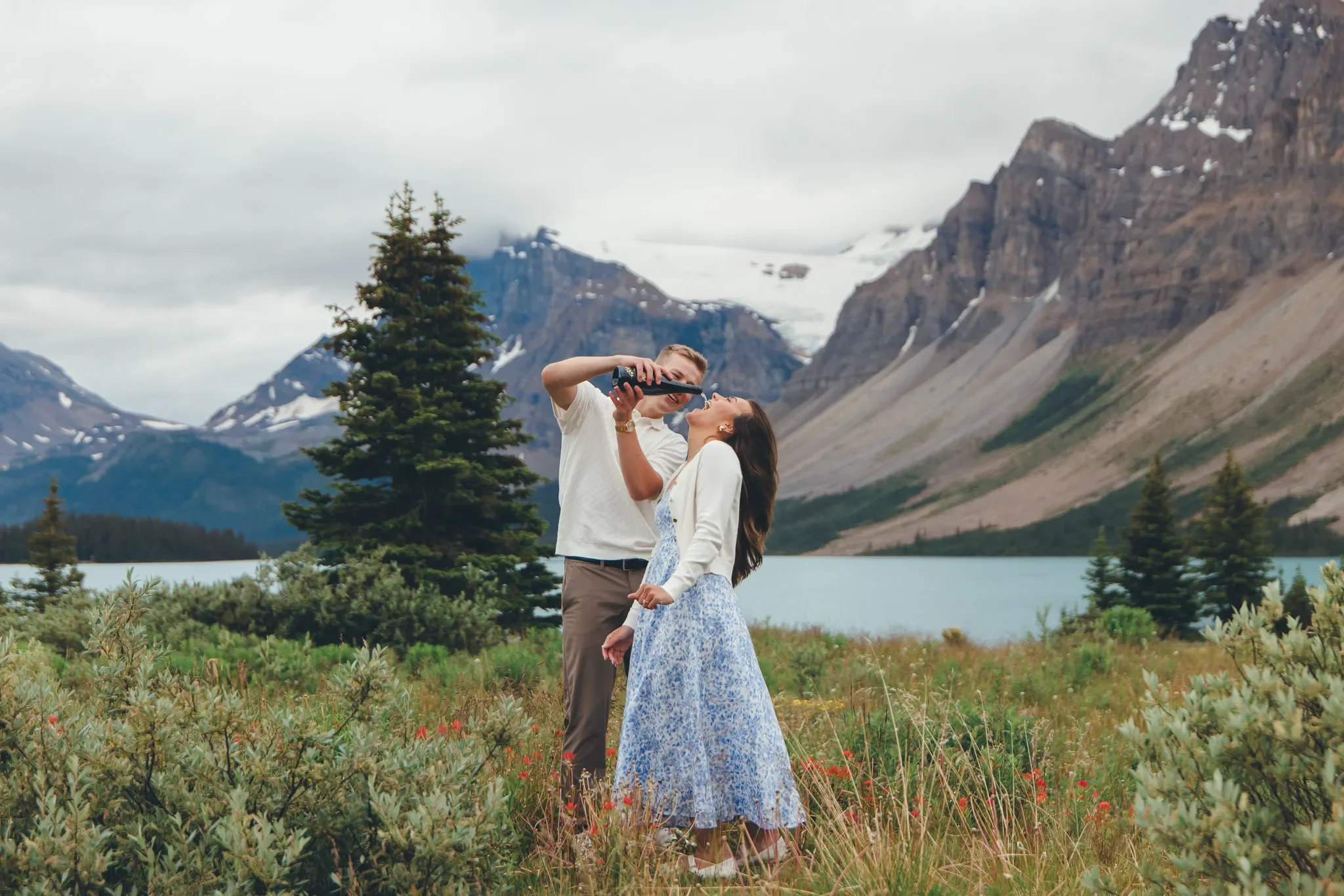154_couple-celebrating-engagement-canadian-rockies-alpine-lake.webp