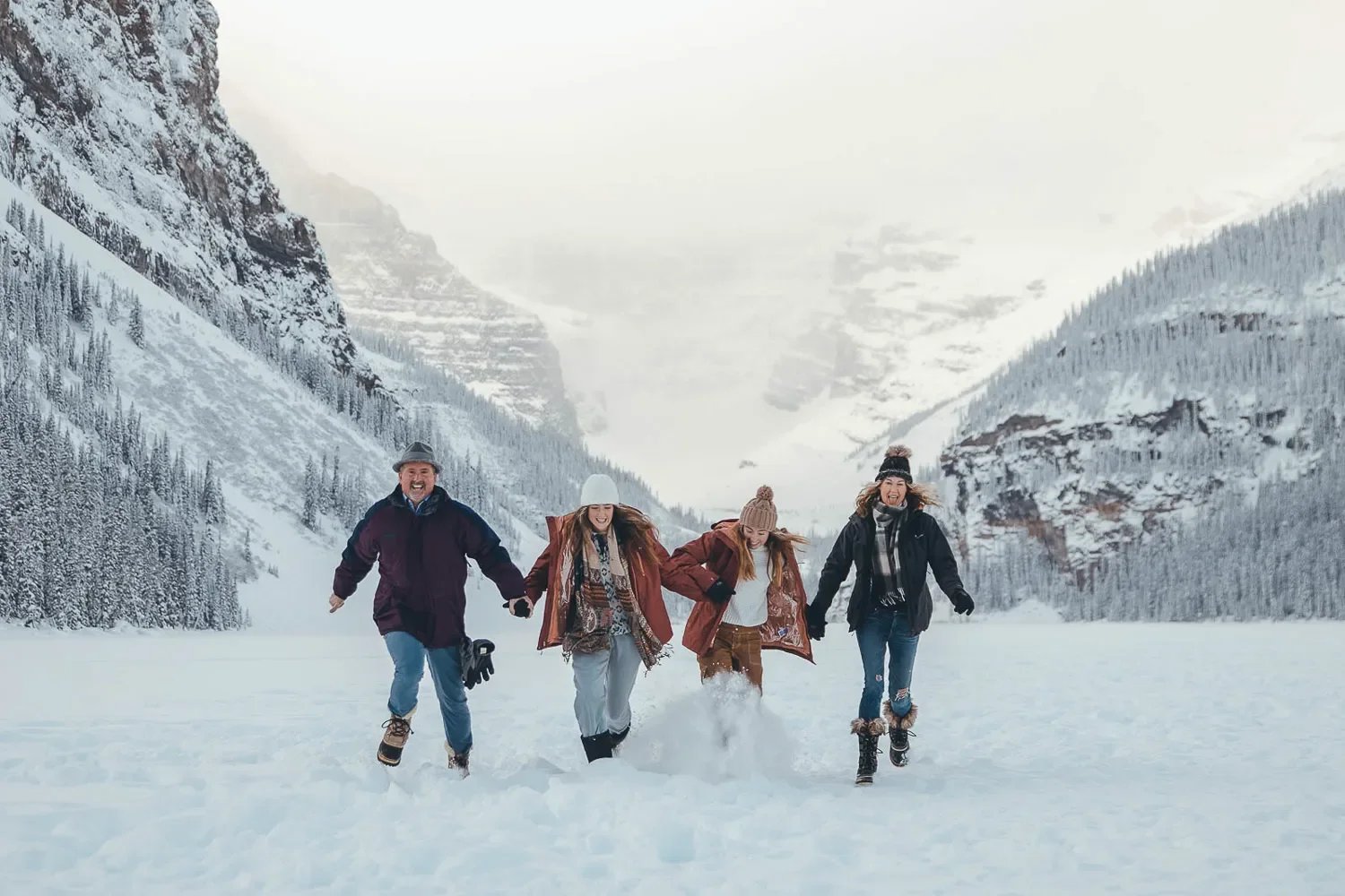 120_Family-Running-Lake-Louise-Winter-Mountains.webp