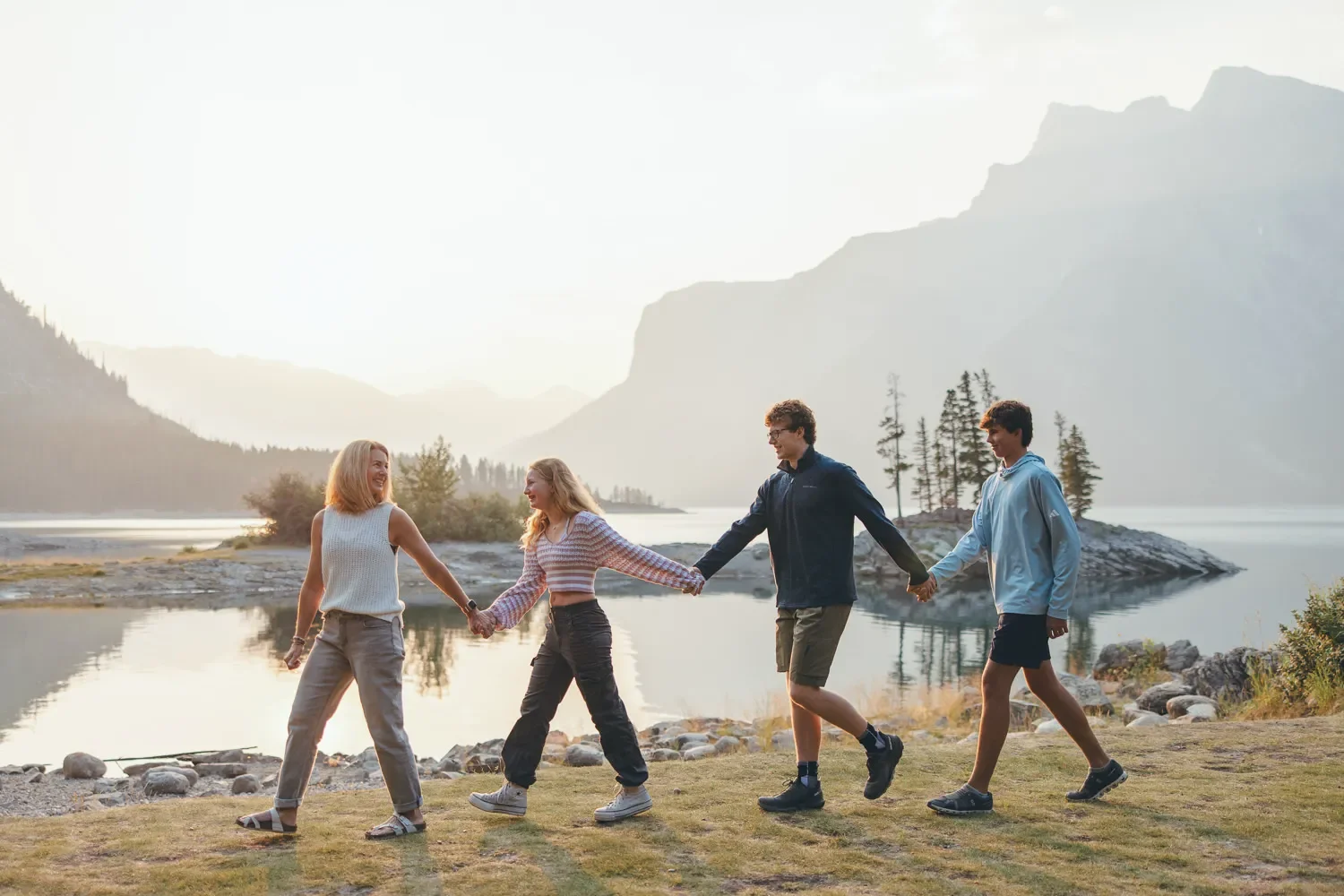 105_family-walking-holding-hands-banff-mountains-golden-hour.webp