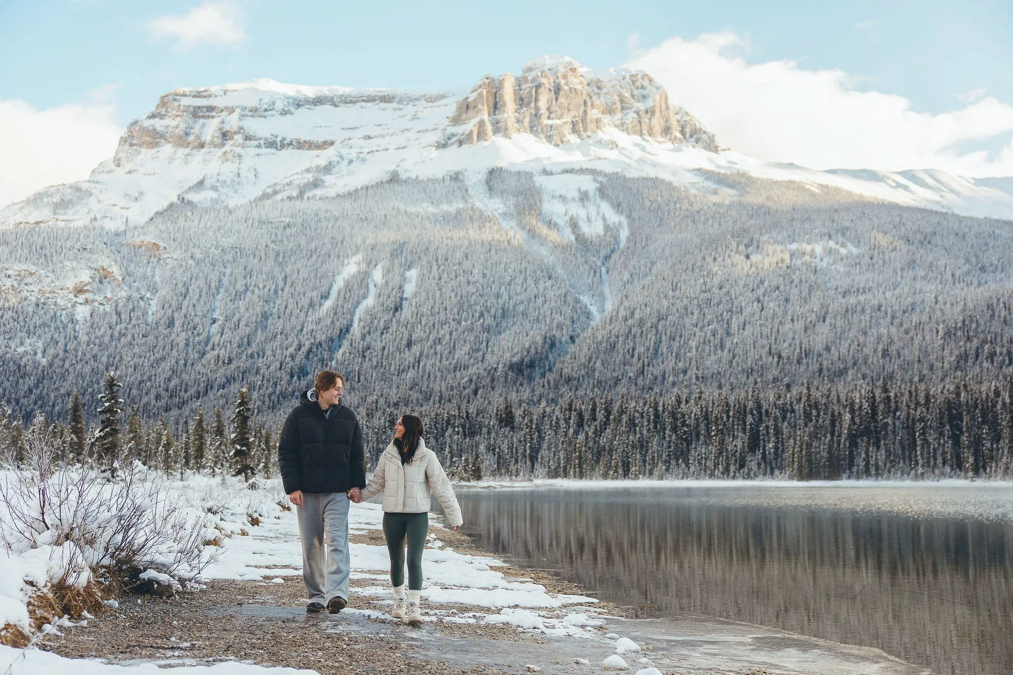 106_Couple-Walking-Snowy-Mountain-Lake-Banff.webp