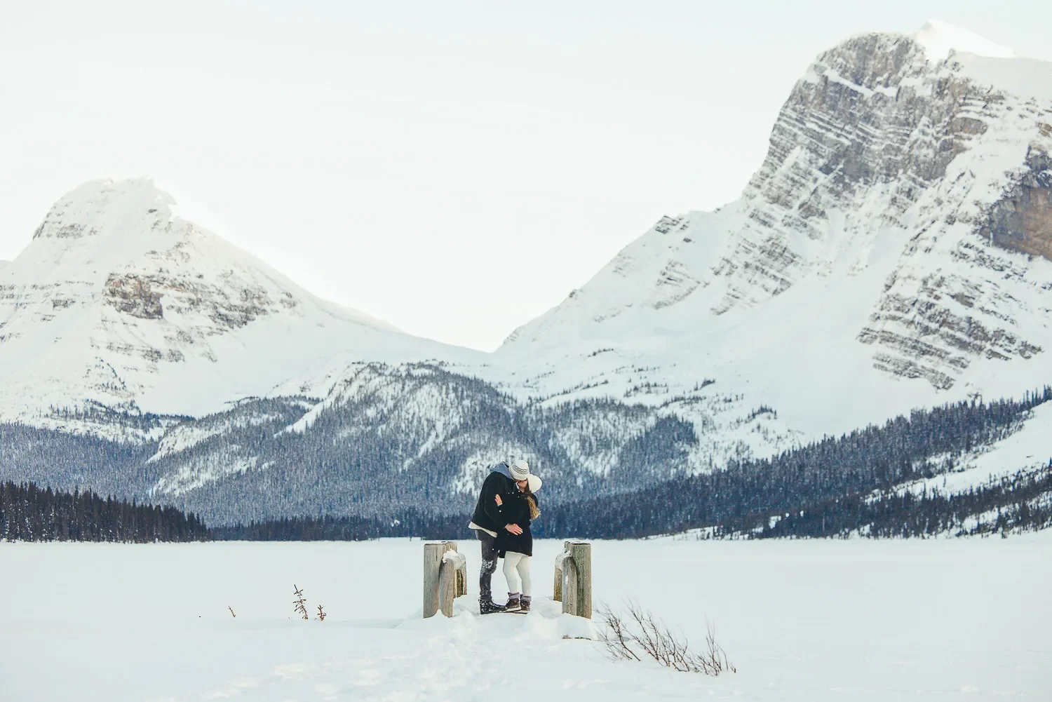 103_Couple-Embracing-Frozen-Alpine-Lake-Canadian-Rockies-Winter.webp