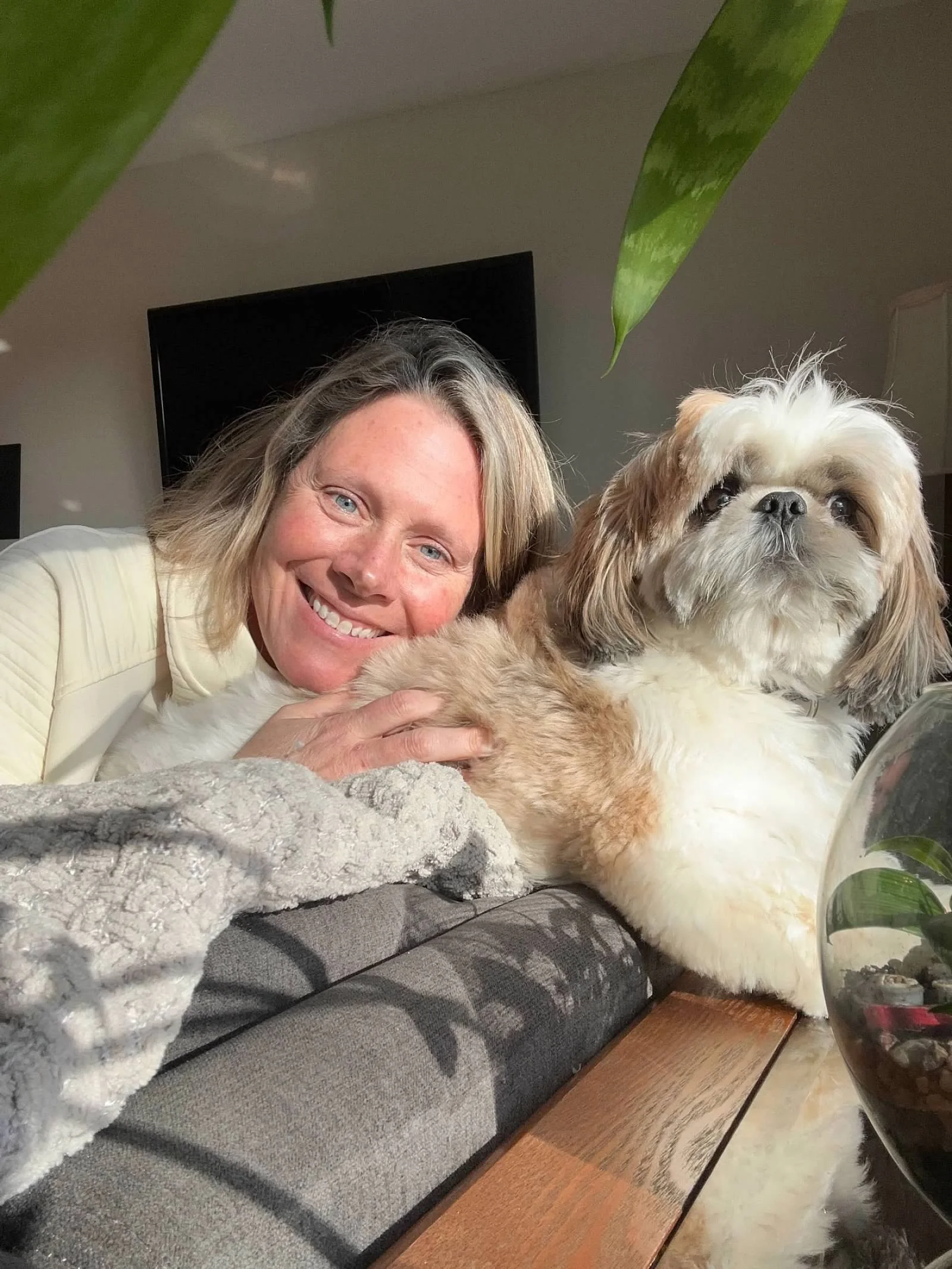 Stephanie Davis, intuitive energy healer and bodyworker, photographed with her dog in a peaceful setting that represents her work supporting women through emotional healing, nervous-system regulation, and soul-led, self-care.