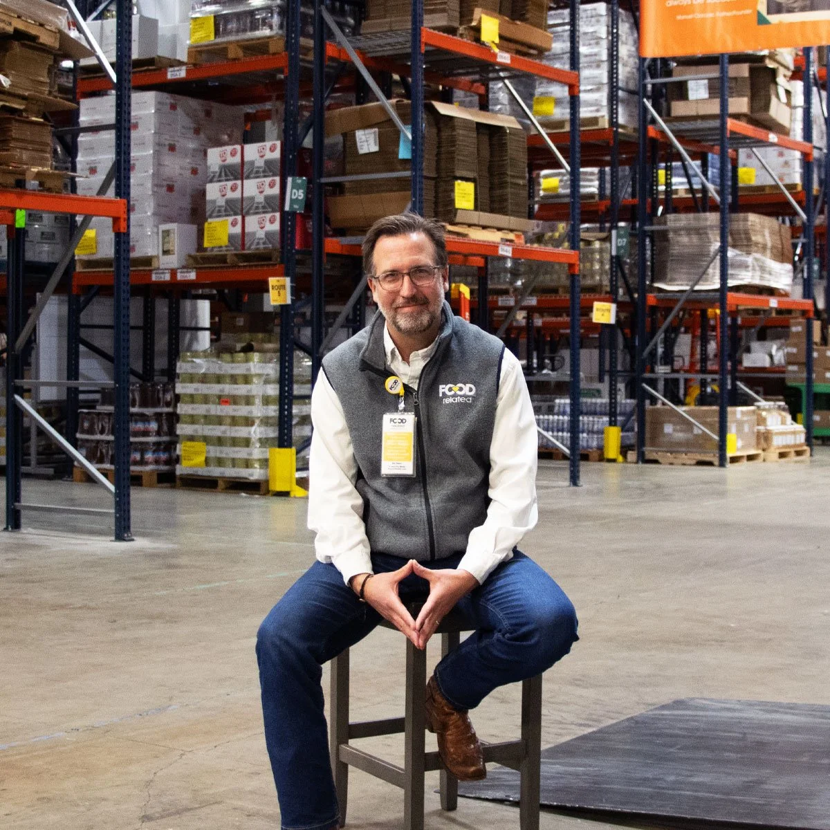 Luciano Ciorciari on stool in warehouse