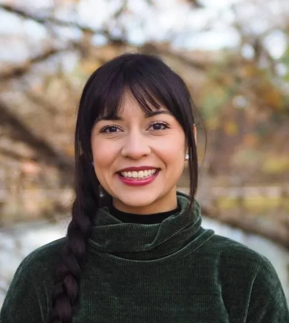 Isabella Vigil outside with trees and water