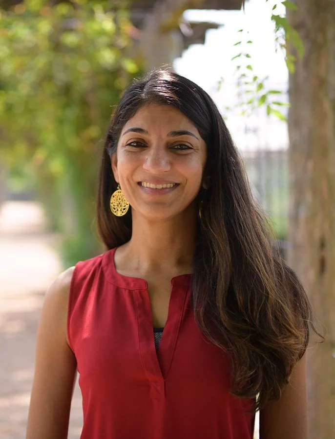 Dr. Shalene Jha outside with trees