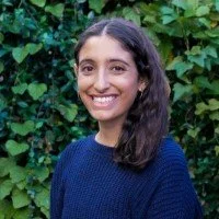 Emily Foxman outside with green vines
