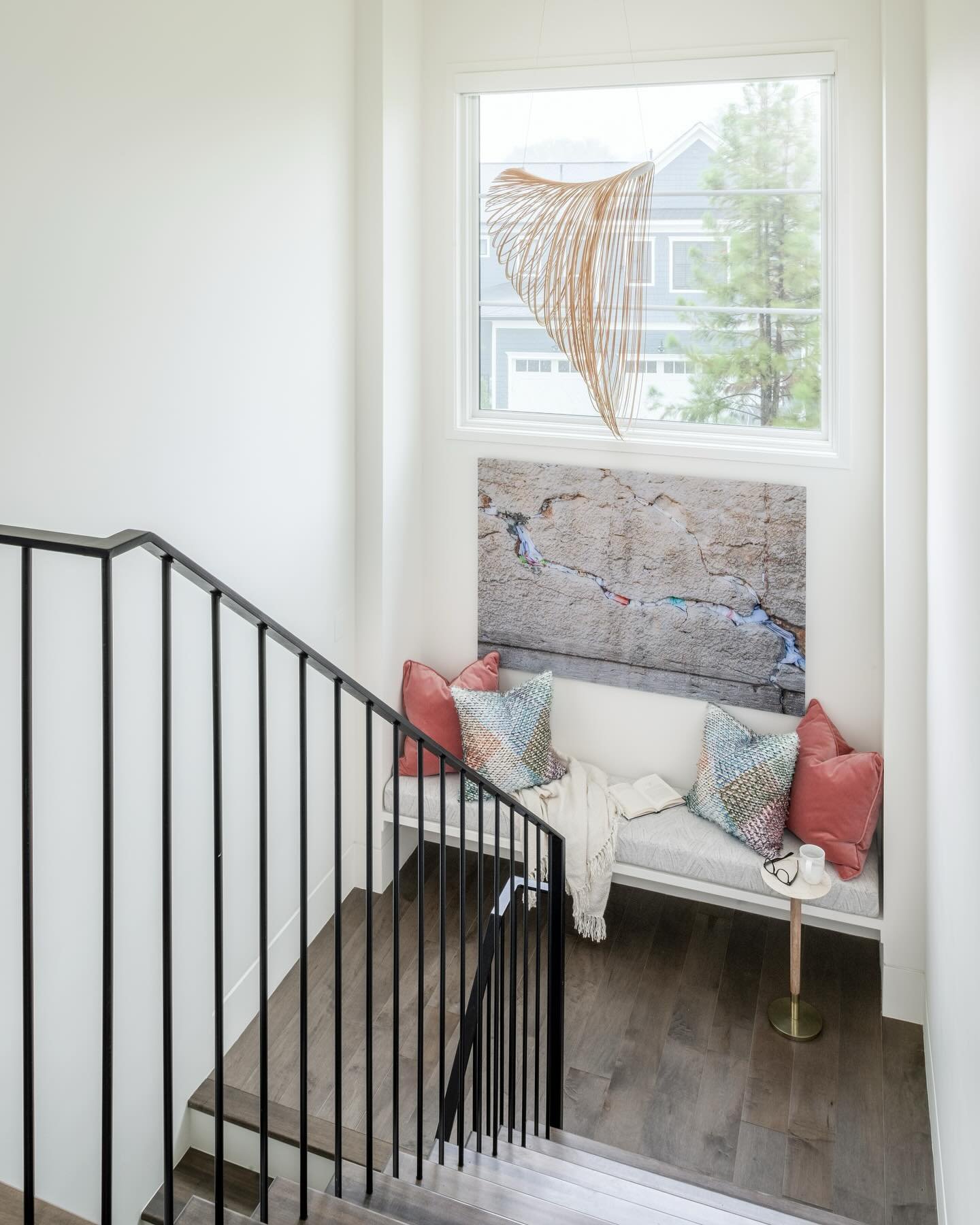 A wide stair landing provides the opportunity to infuse aesthetic interest in this Rockville new build home - featuring a sculptural light fixture, sleek handrail, custom floating bench, and large scale art. 

📸: @radiferaphotography 

#artdesignpar