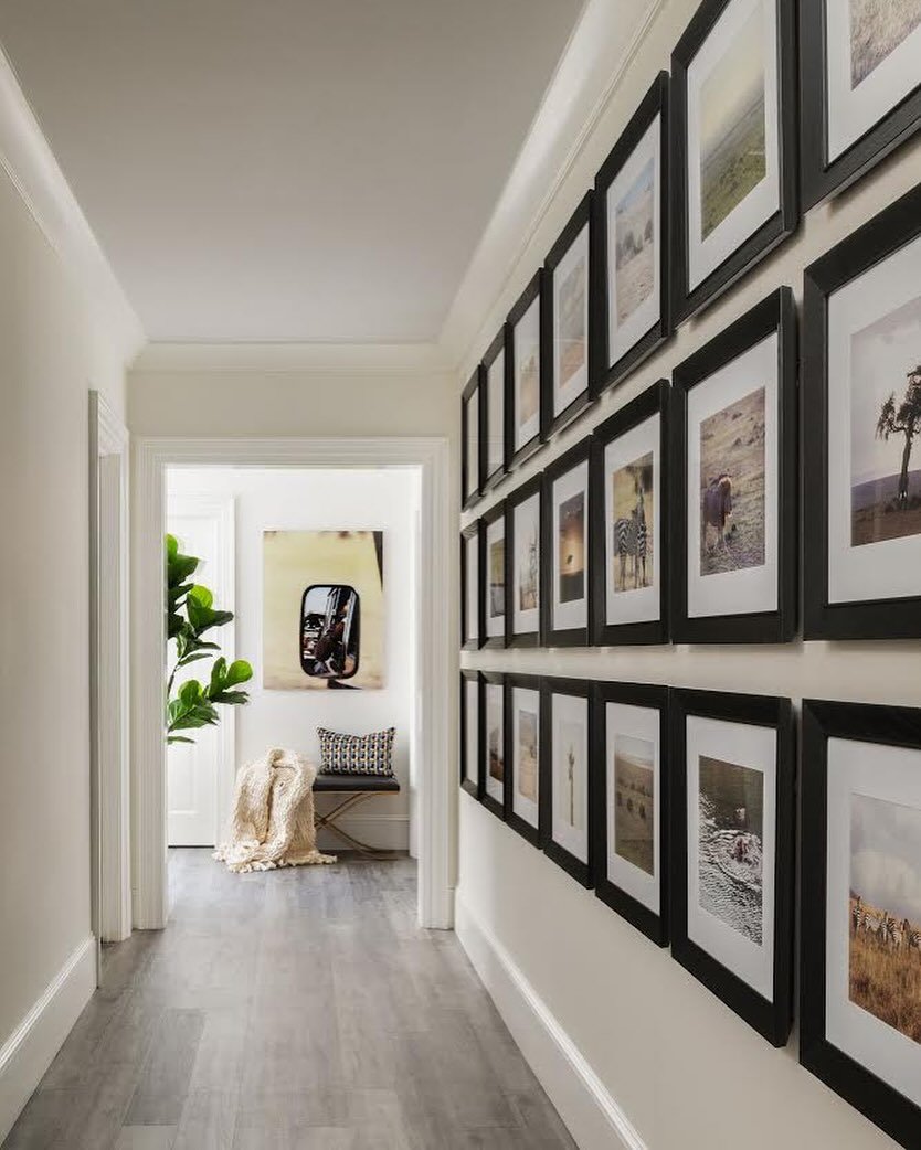 Family vacation photos line this Basement&rsquo;s hallway, creating a walk down memory lane. 

📸 : @radiferaphotography 

#artdesignpartners #homedesign #hallwaydesign #art #moderndesign #contemporarydesign #timelessinteriors #interiorstyling #inter