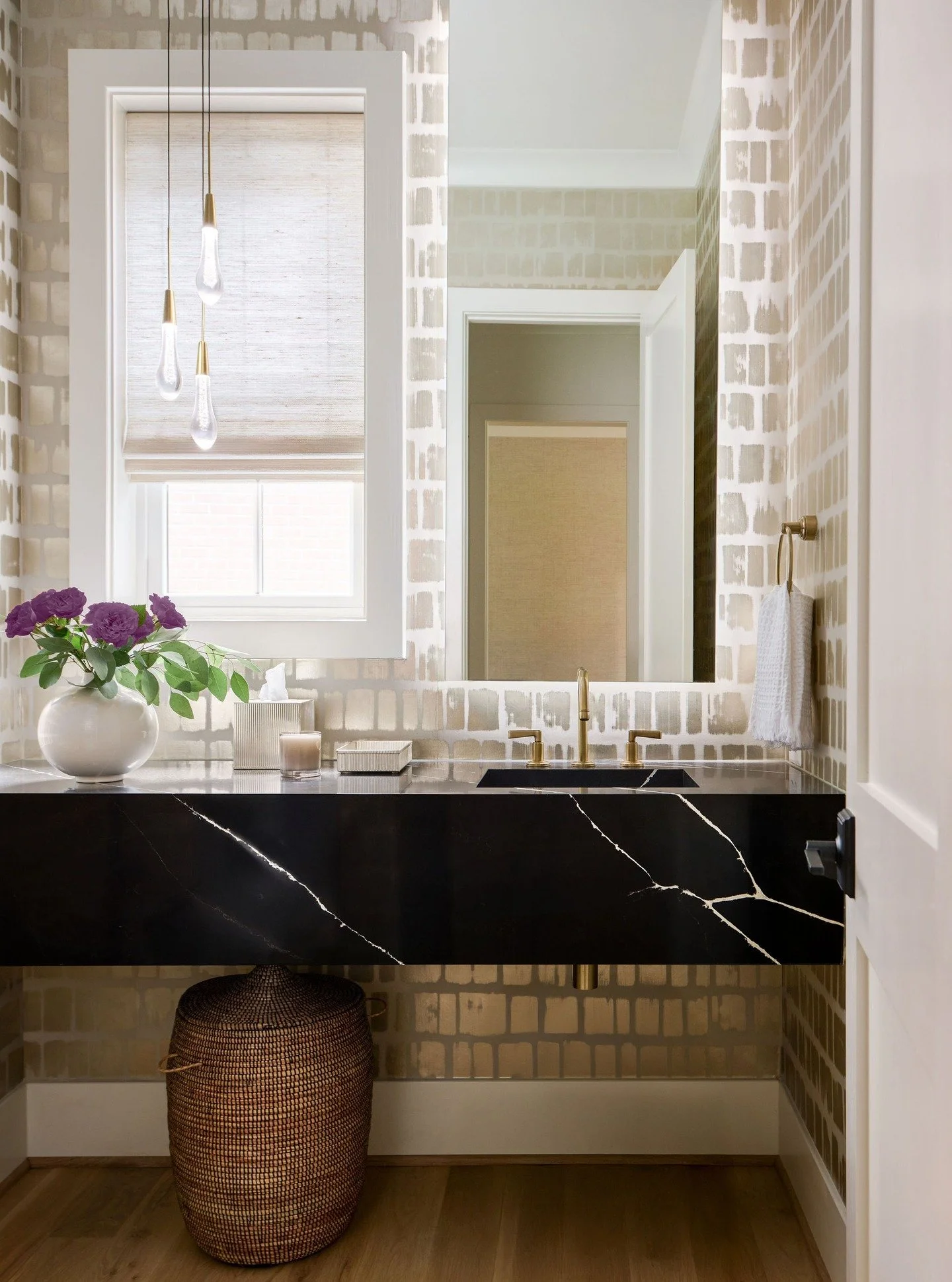 Natural light, a lit mirror, and decorative pendants give this dramatic Powder Room design serious staying power!
📸 : @radiferaphotography 
#artdesignpartners #homedesign #moderndesign #powderroomdesign #timeless #timelessinteriors #interiorstylin