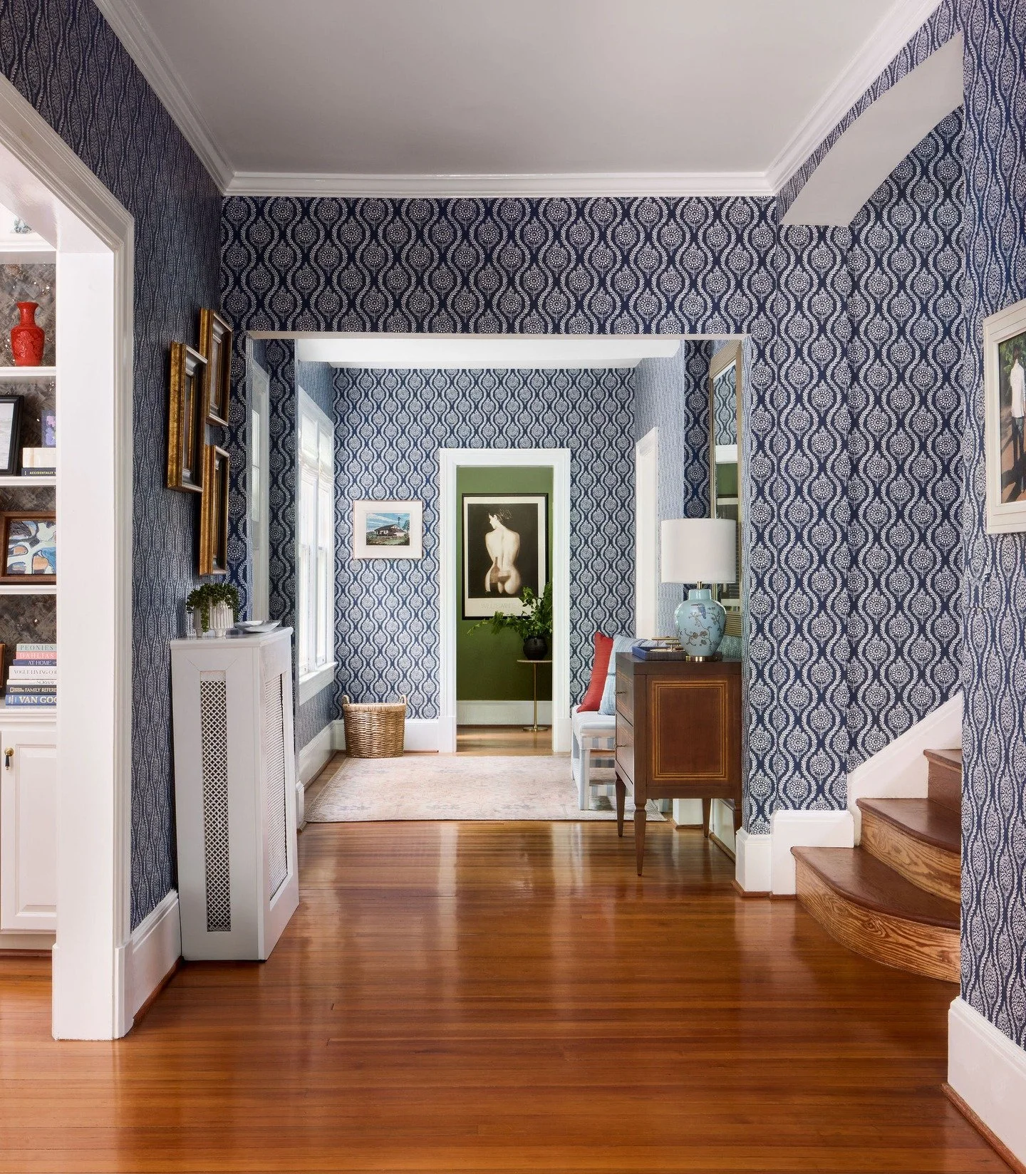 A welcoming entrance to our clients&rsquo; historic home starts the narrative of both the structure itself and the family who occupies it. Bold blue wallpaper comes alive when paired with rich walnut wood, brass, and pea green paint. 

📸 : @radifera
