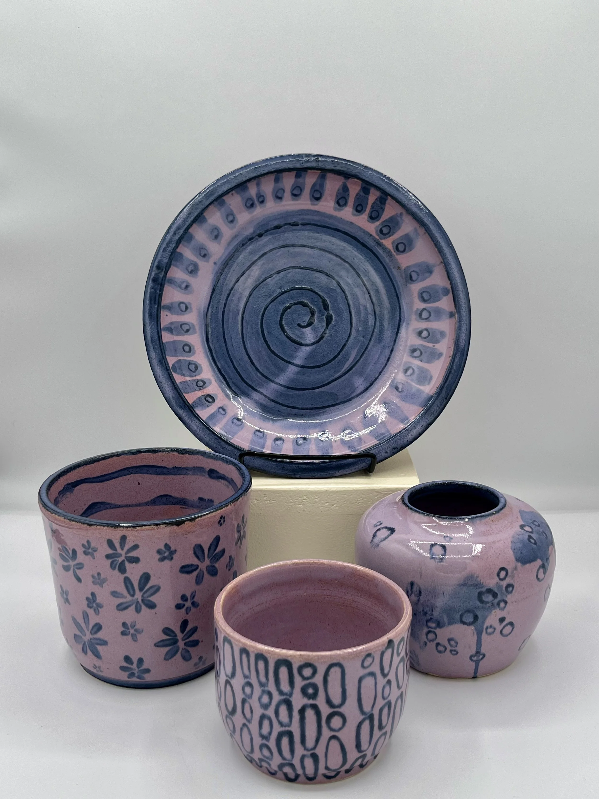 collection of pieces, Purple Dusk over black underglaze. 