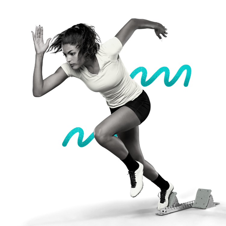 A woman in athletic clothing is in a sprinting pose on starting blocks.
