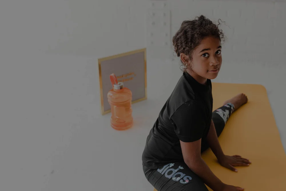 A child building mobility through a guided stretch