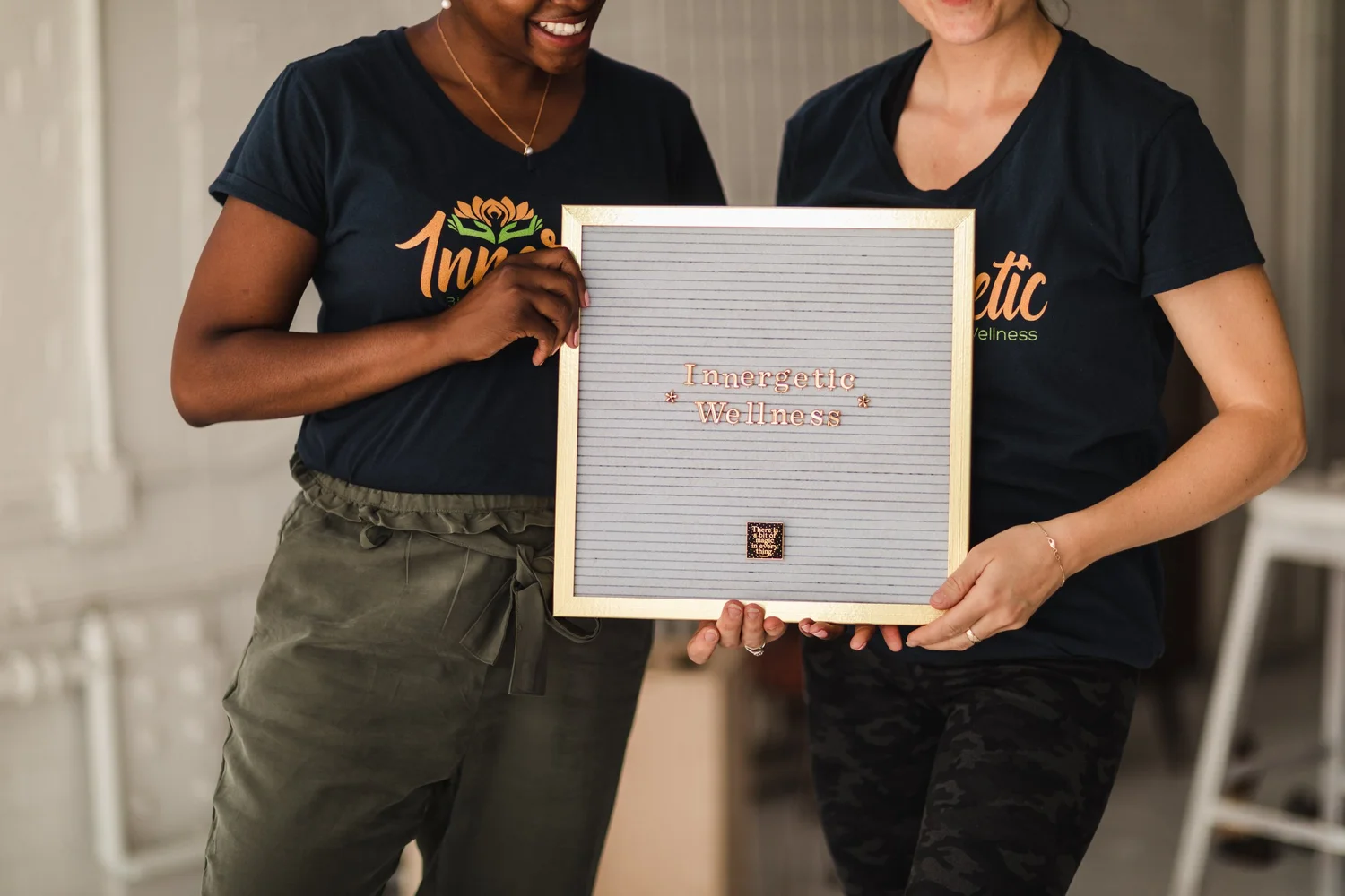 Two Innergetic team members holding an Innergetic Wellness sign
