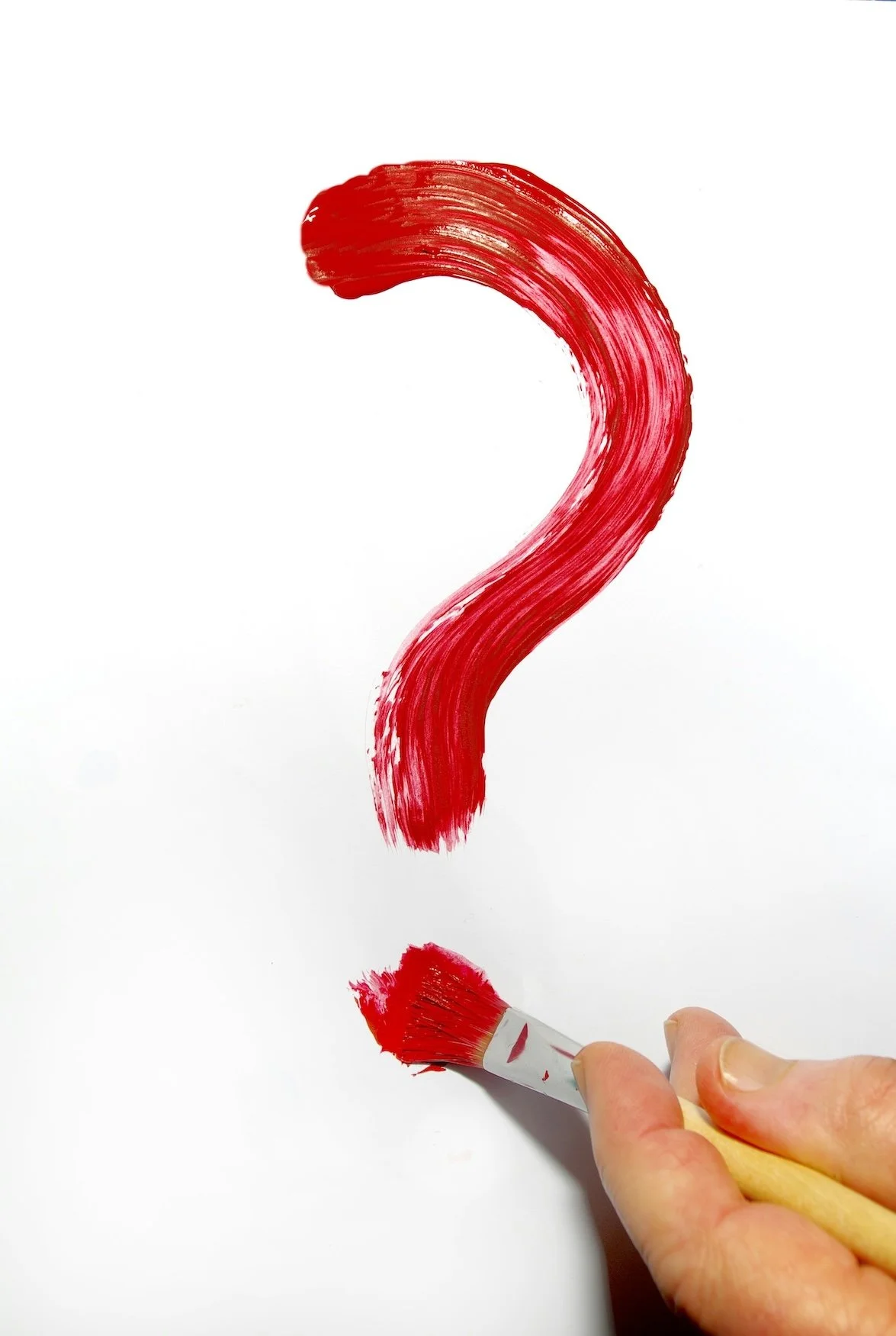 A question mark painted in red