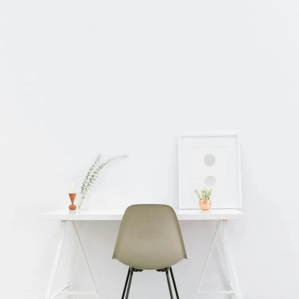 A minimalist white room with a white desk | Aesthetic vs. world-building