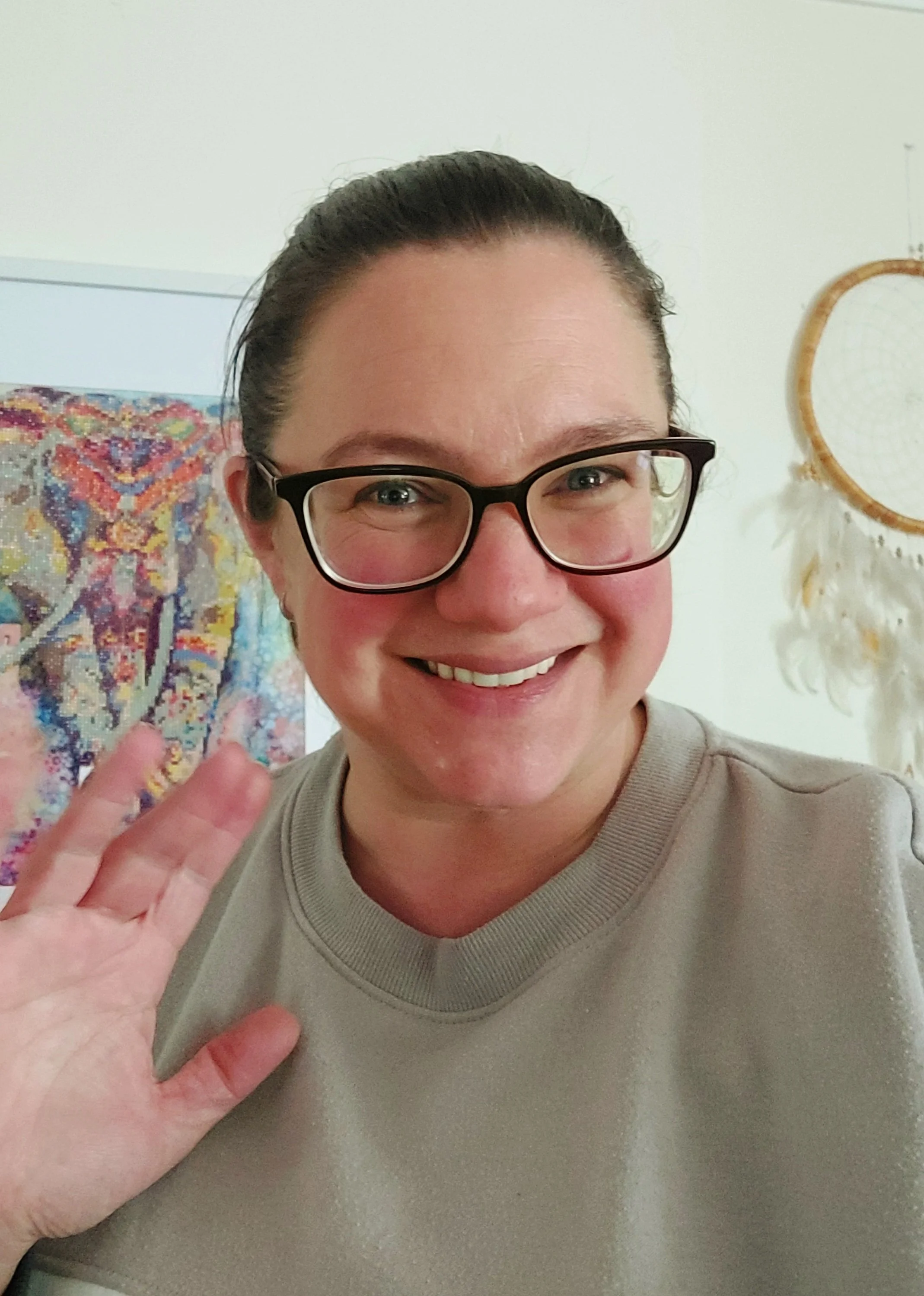 Tania-Portrait-Head-Shot-Smile-Glasses-Ponytail-Wave-Hand-Elephant-Art-Background