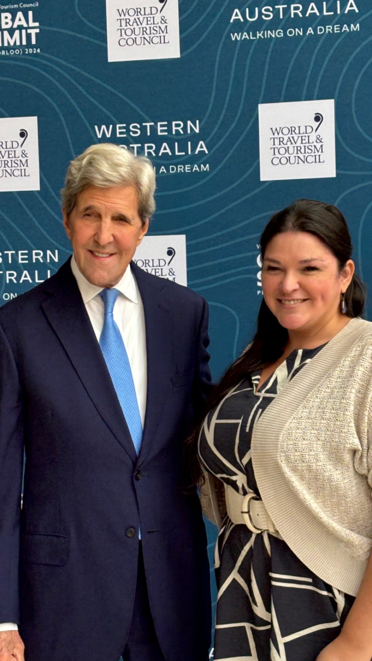 Dawnielle Tehama, Senior Associate Principal of Coraggio Group joins John Kerry, the 68th Secretary of State for a photo op.