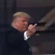 A man resembling Donald Trump pointing a finger outward.