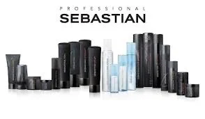 Hair care products arranged in a line, including shampoos and conditioners, in black and clear bottles.