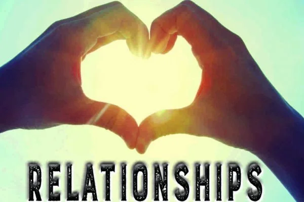 Two hands forming a heart shape with the sun shining through the middle, and the word 'RELATIONSHIPS' written below.