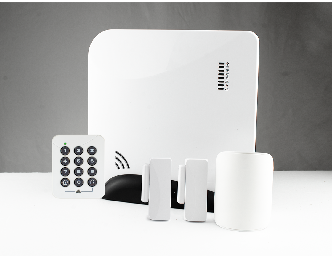 Set of smart home security devices including a white keypad with black buttons, a large white control panel, two white motion sensors, and a white smart speaker on a white surface with a gray background.