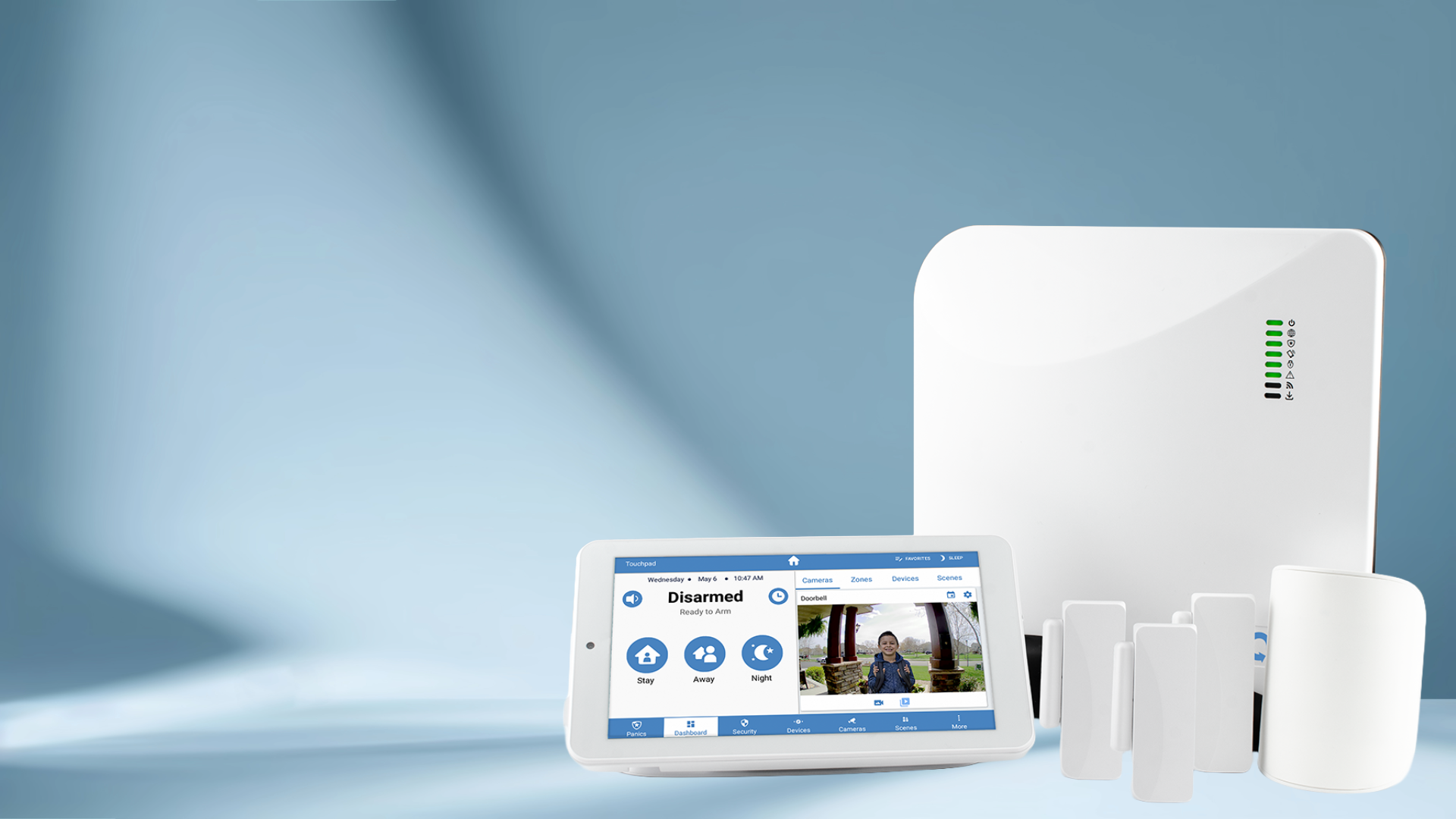 Home security system setup including a white control panel, a tablet displaying security statuses and a live camera feed, and several white door/window sensors against a soft blue background.