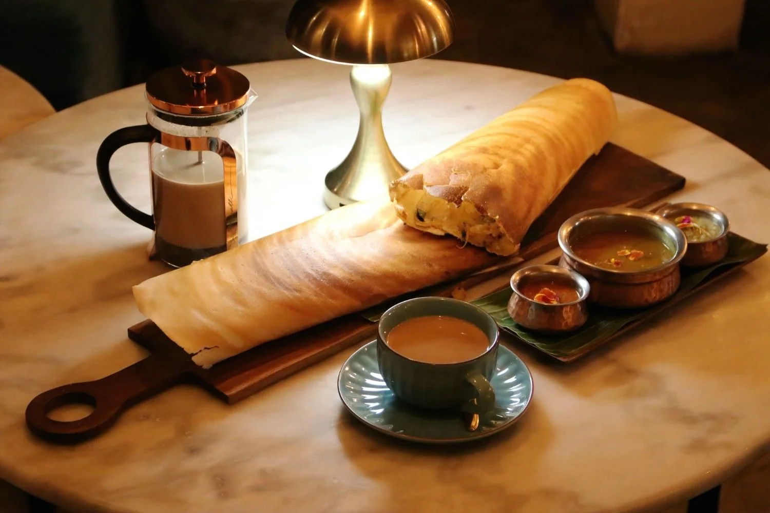 The Big Pesona Dosa served with sambar, coconut chutney, tomato chutney, and Indian masala chai at Pesona Lounge Trawangan.