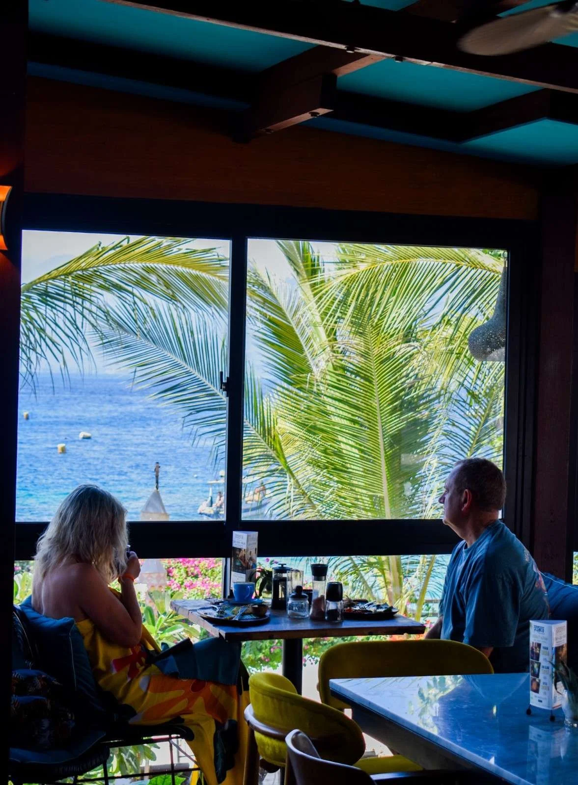 Guests enjoying indoor dining at an air-conditioned restaurant in Gili Trawangan