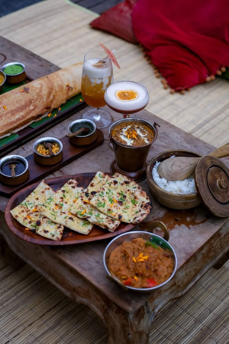 Freshly baked garlic naan served with authentic Indian curries, steamed rice, and traditional condiments at Pesona Lounge Trawangan.