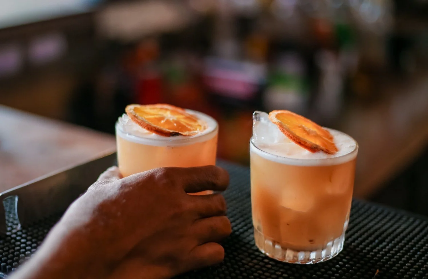 guest grabbing pesona signature amaretto sour