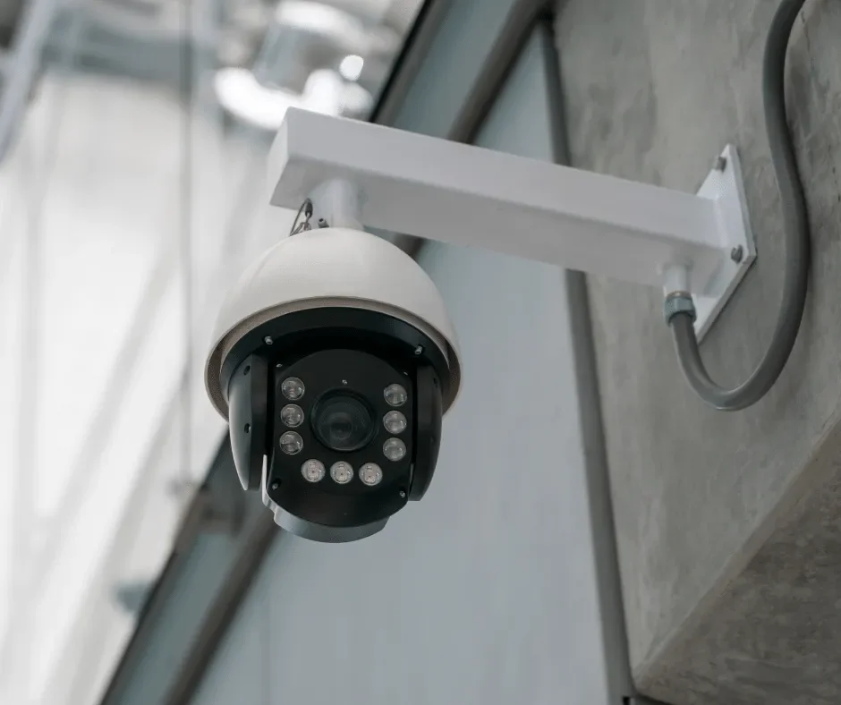 A security camera mounted on a concrete wall.