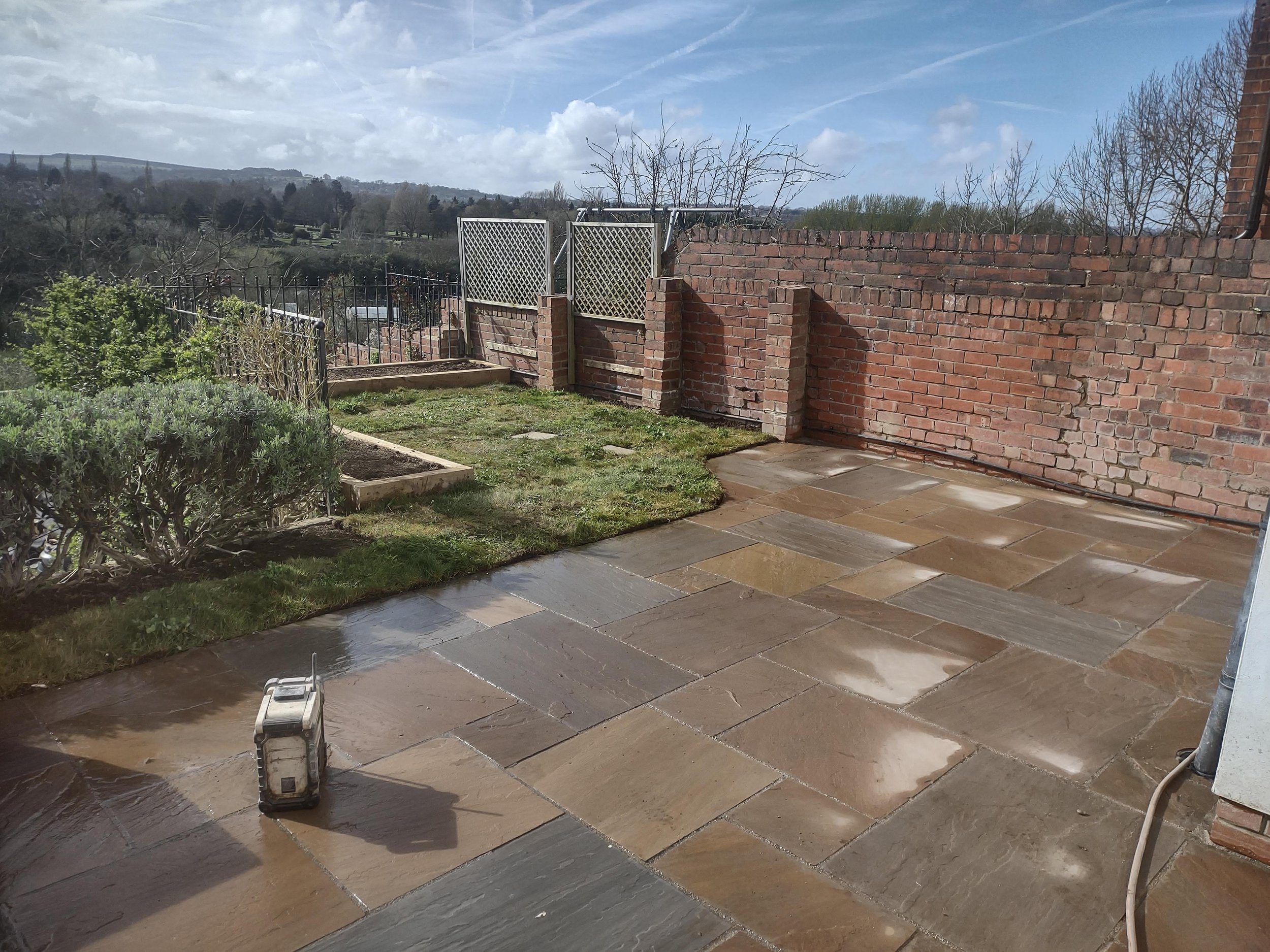 Autumn Brown paving. sleeper raised beds and wildflower turf