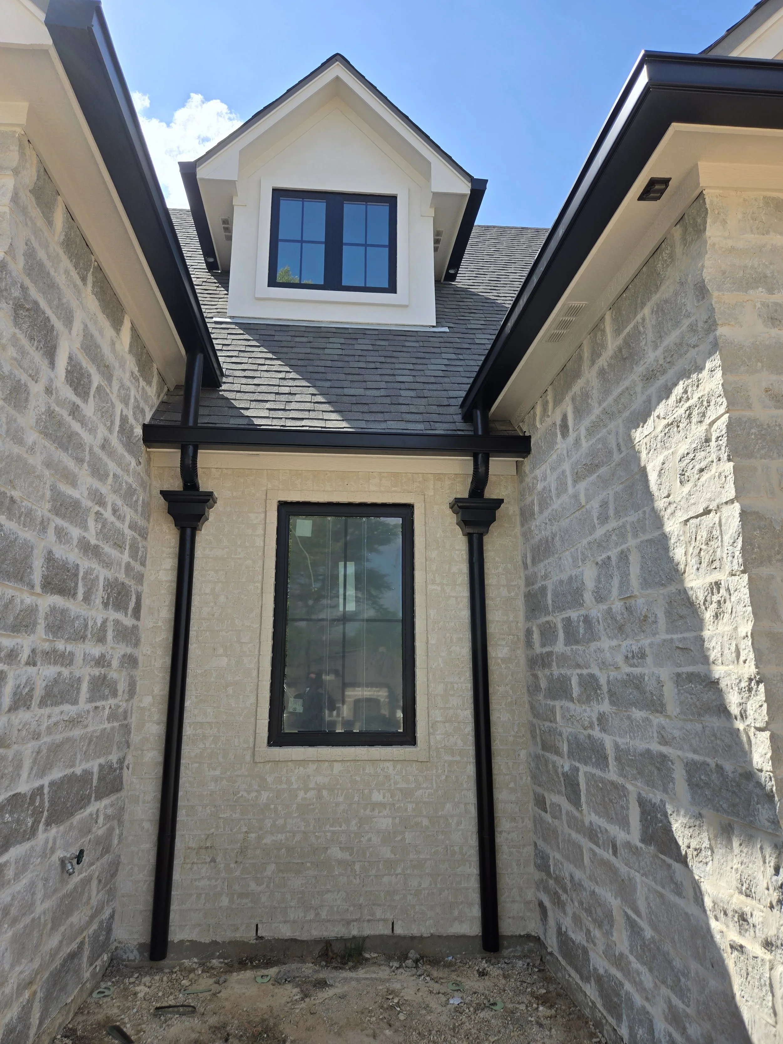 Black Seamless Box Gutter with Round downspouts and Conductor Heads