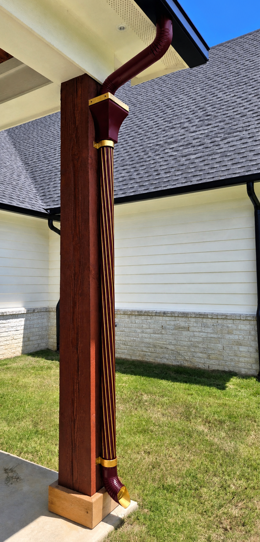 gold-edged burgundy spiral downspout