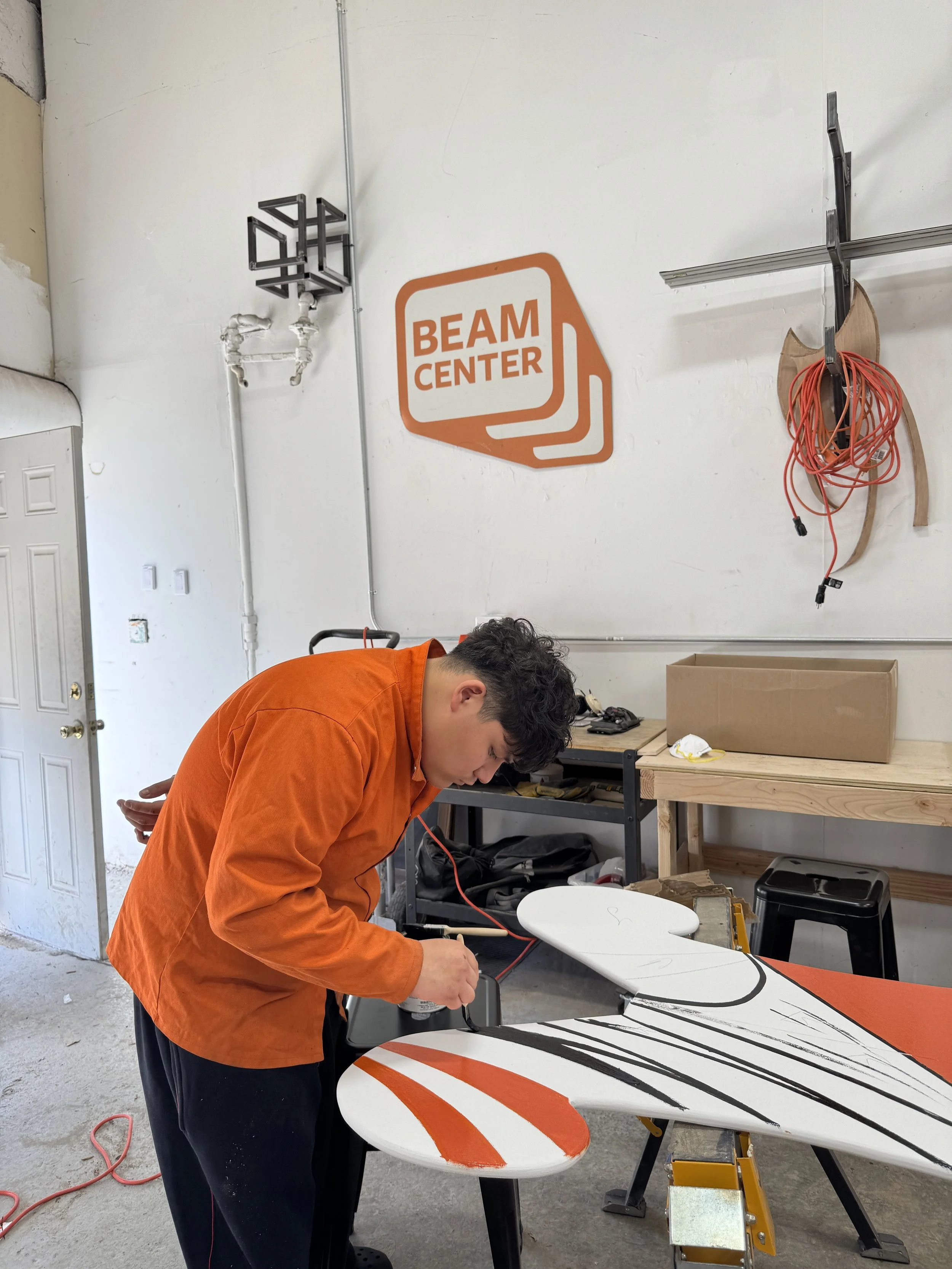 chris painting beam sign.JPG