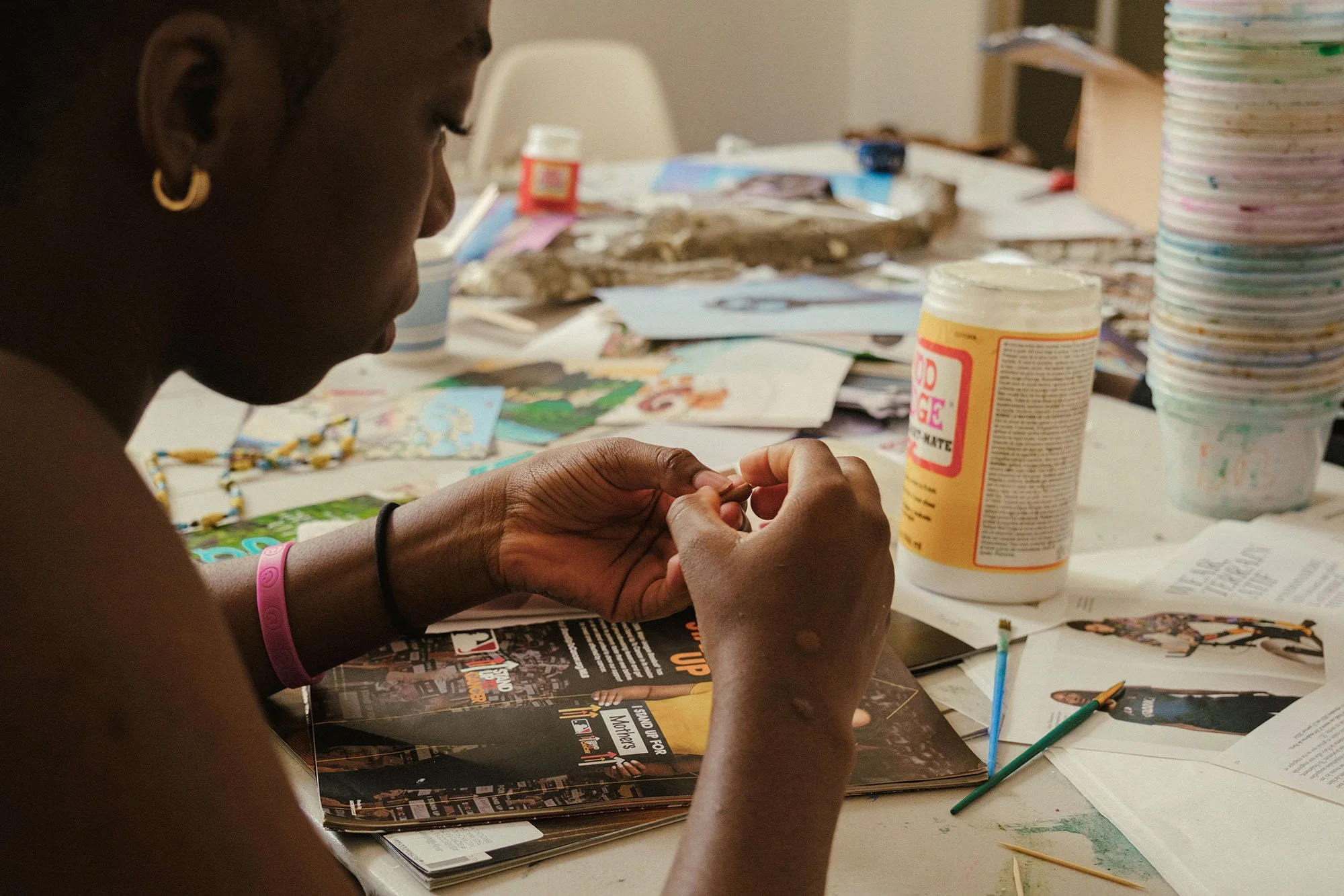 Young girl working with beads and modge podge