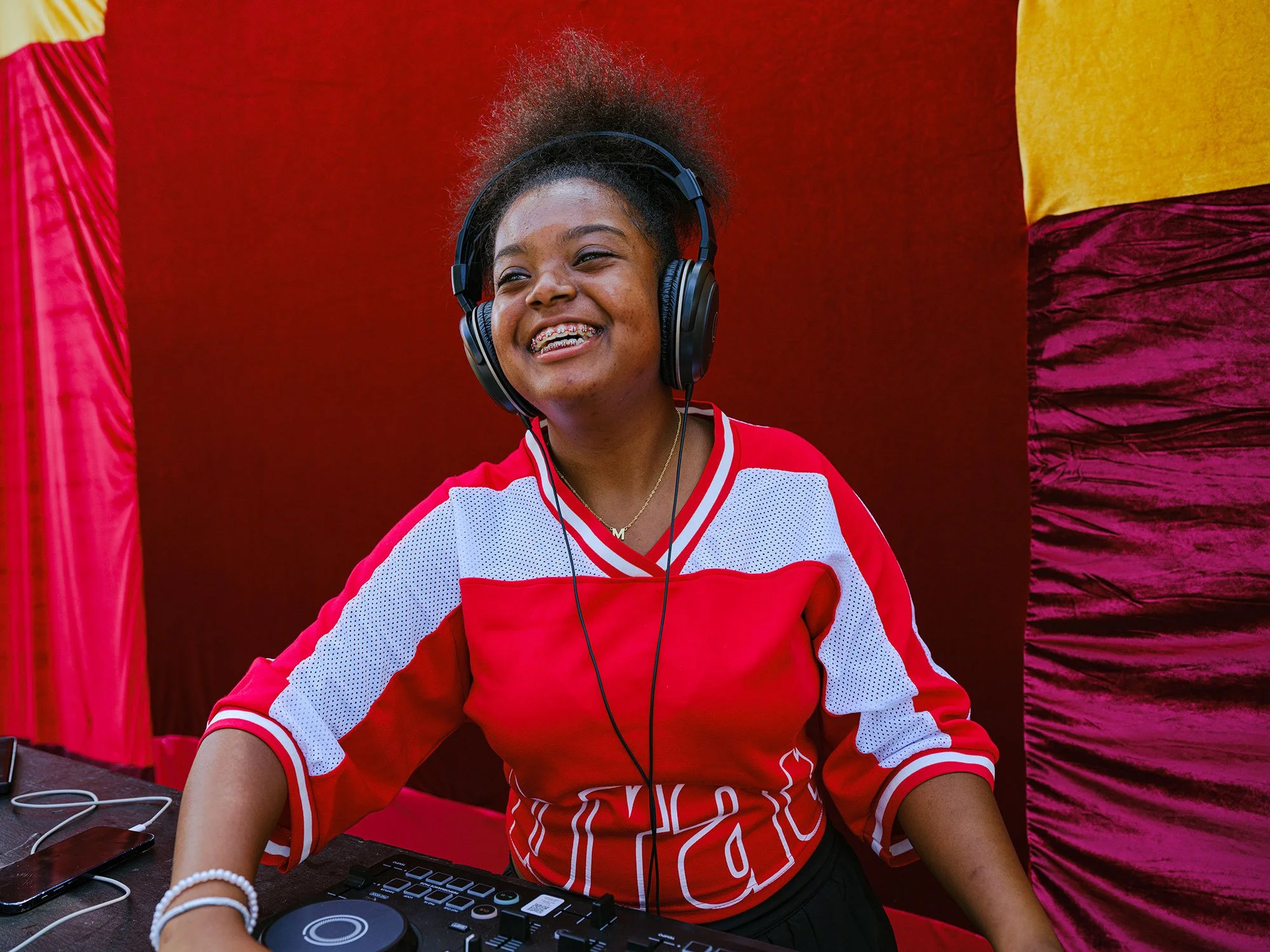 Young girl smiling while working at a music production table