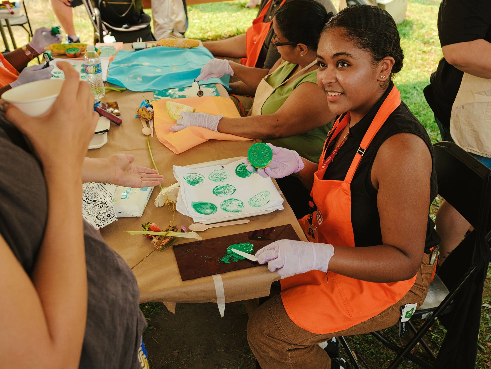 Student using citrus as a stamp with paint.